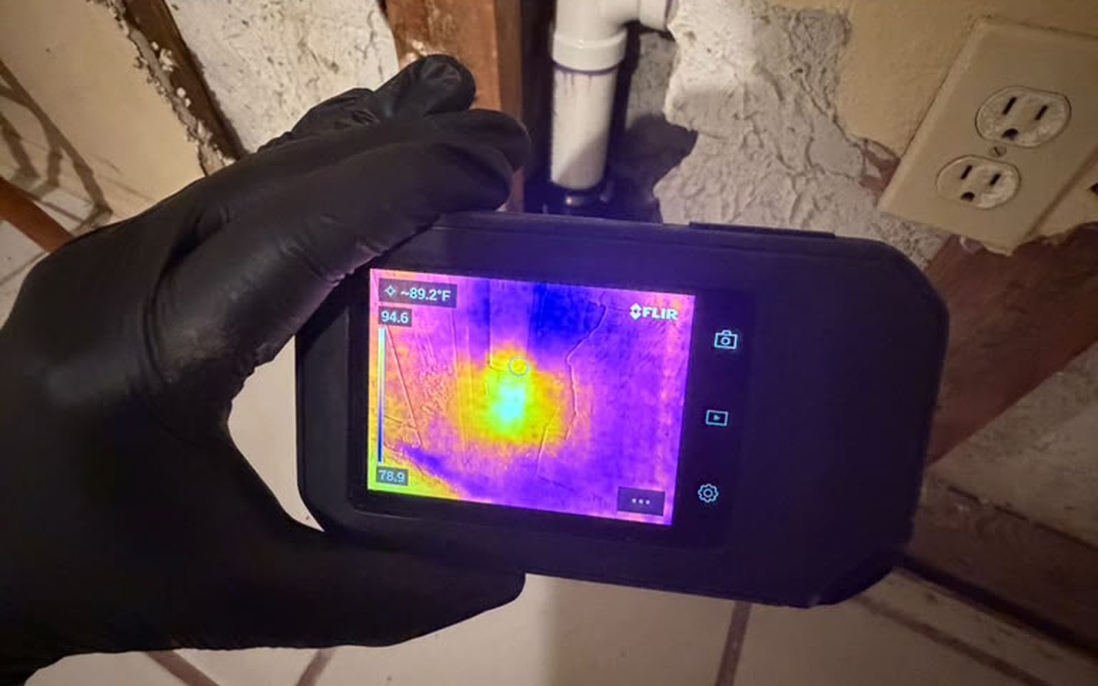 Thermal imaging camera detecting hidden moisture behind a wall
