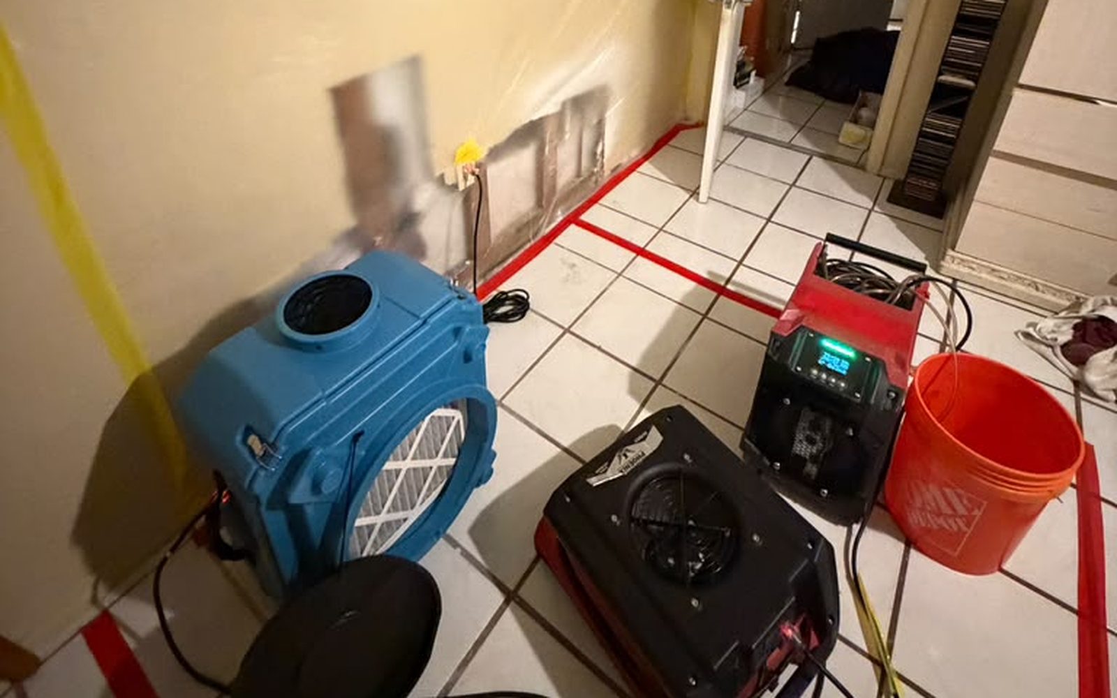Air movers and a dehumidifier drying a Florida home after water damage